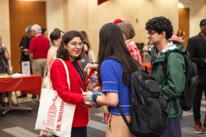 Student shakes hands with Dean Nita Ahuja.