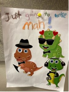 Dinosaurs with hats, headphones and sunglasses with handwriting that says "just going to work man!"