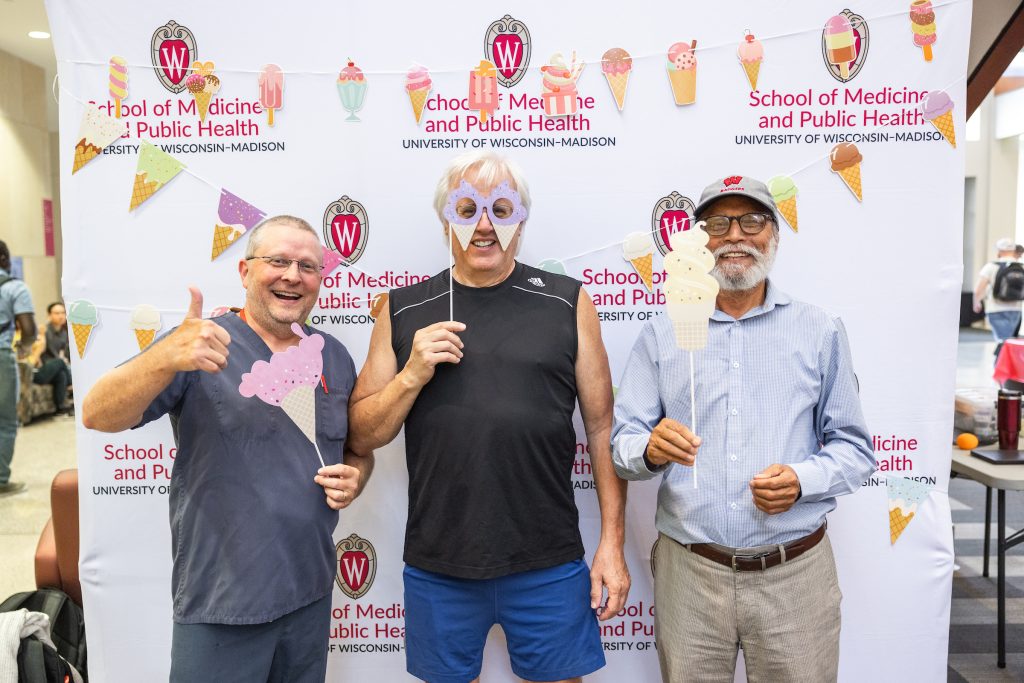 People pose with fun props at the social.