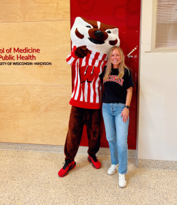 Jessi Scrima-Bailey smiles with Bucky Badger