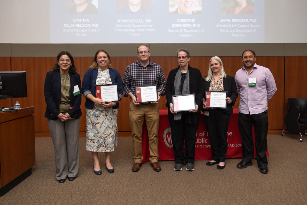 Dean's Research Staff Awards recipients smiling together with Dean Ahuja and Jon Audhya
