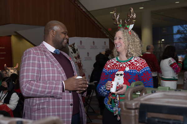 SMPH faculty dress in festive attire at the 2025 SMPH Sweater Weather Social.