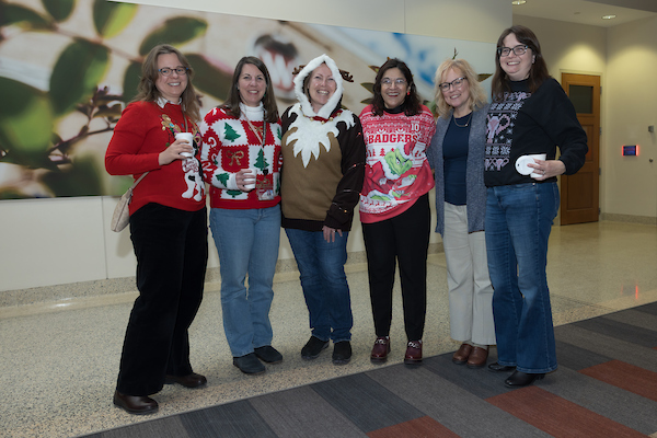 Dean Nita Ahuja and other SMPH faculty pose at the 2025 SMPH Sweater Weather Social.