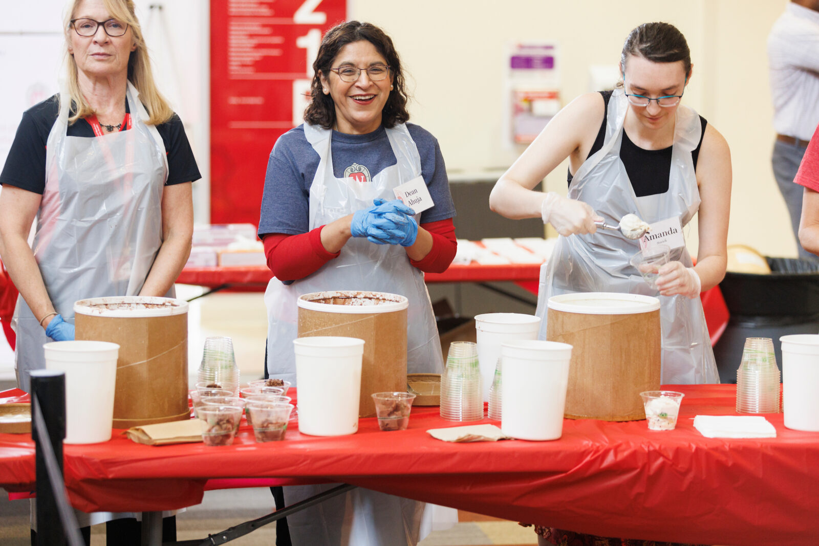 Dean Ahuja serves Babcock ice cream alongside SMPH staff.