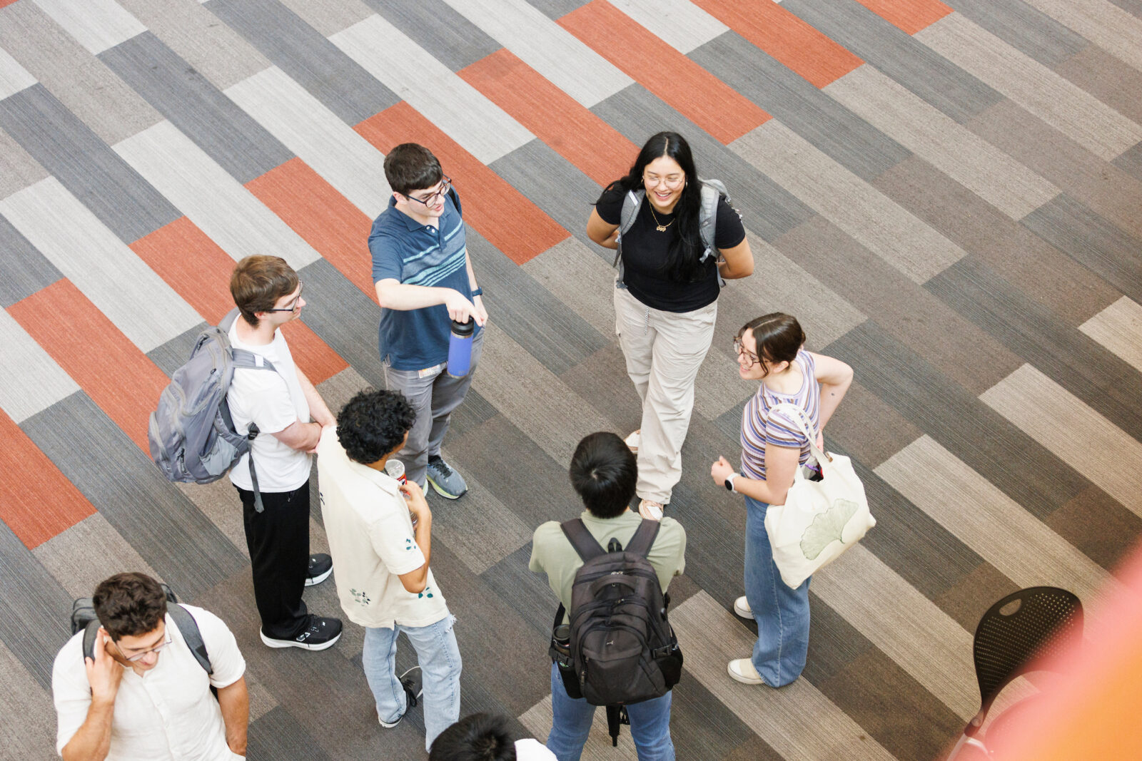 Students meet in a circle, conversing at the Ice Cream Social.